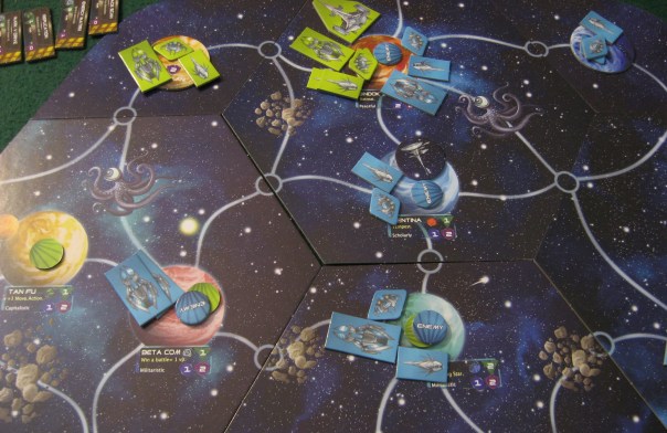 The cardboard pieces work better than plastic figures, actually. You can stack them and their different sizes makes the stacks remain readable.