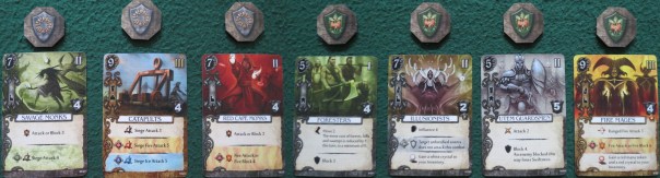 One of the reasons Mage Knight appears so immensely difficult is because you've got a whole bunch of STUFF. There are action cards for each character, advanced action cards, wound cards, spell cards, artifact cards (and all of these with the same back, since the game is fundamentally a large and complex deck-builder), and two different classes of unit cards. You can see the difference between the basic and elite units above — the elite cards have a gold background rather than silver. One of the reasons Mage Knight appears so immensely difficult is because you've got a whole bunch of STUFF. There are action cards for each character, advanced action cards, wound cards, spell cards, artifact cards (and all of these with the same back, since the game is fundamentally a large and complex deck-builder), and two different classes of unit cards. You can see the difference between the basic and elite units above — the elite cards have a gold background rather than silver.