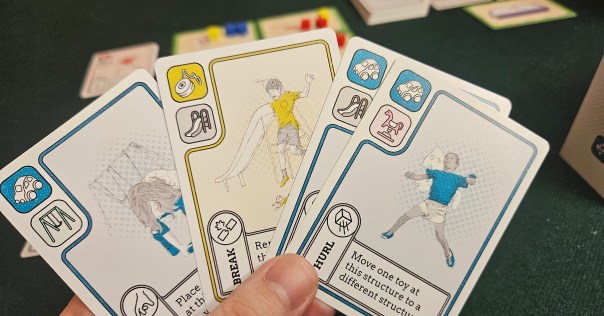 These cards are so dang functional. Even ignoring the icons, the kids show which toy they prefer (the color of their clothes), where they can act (the playground equipment in the background), and which action their card can take (the kid's pose). But it makes me laugh how the rocking horse looks like the child is being haunted by a ghost.